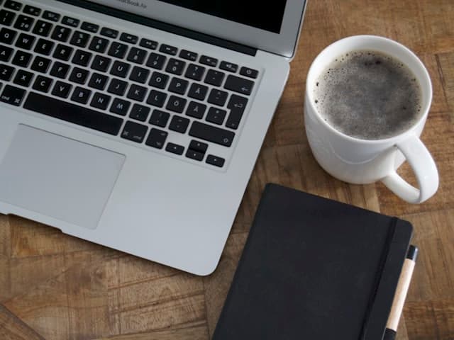 Laptop and coffee on a desk